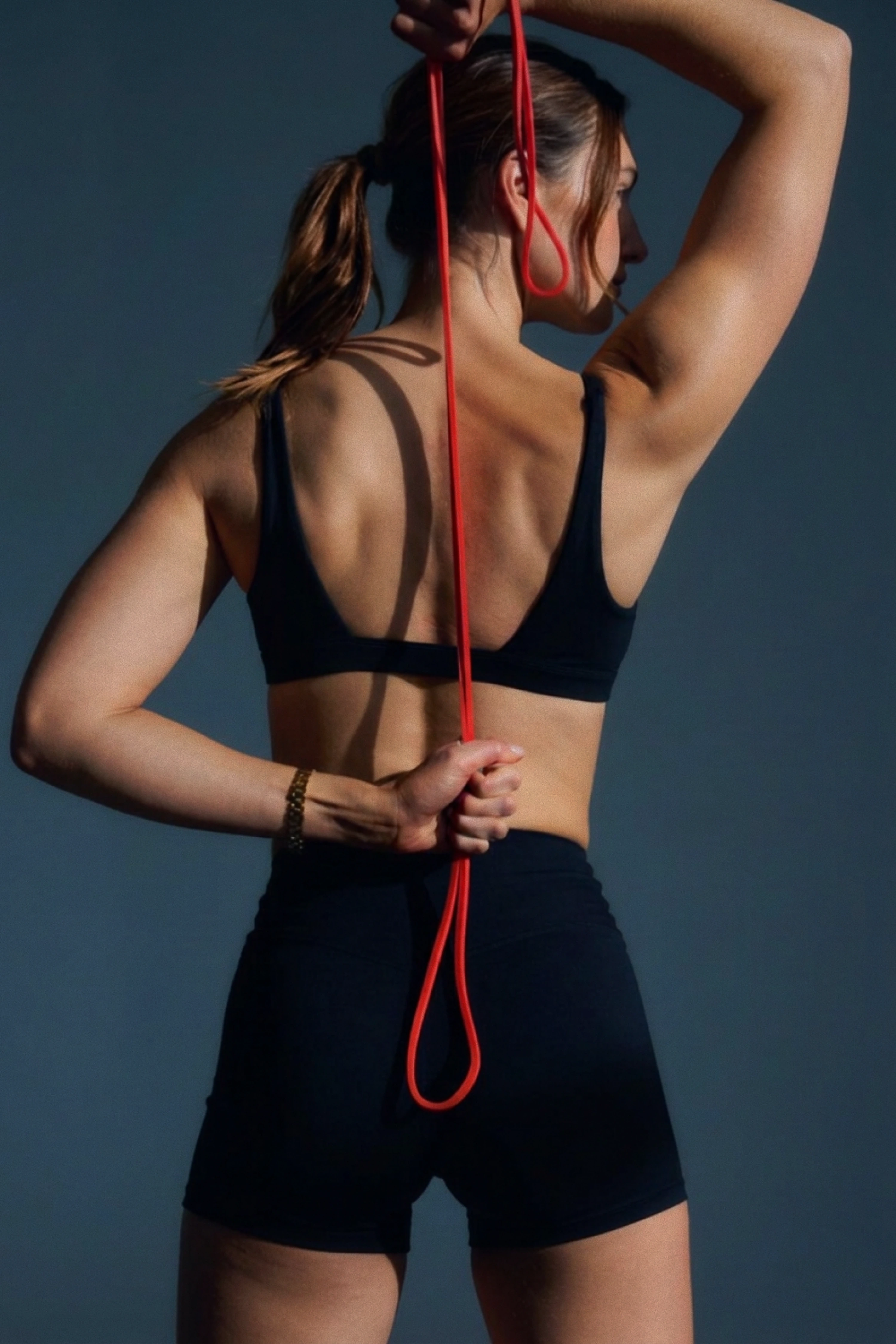 Athlete stretching with a red resistance band